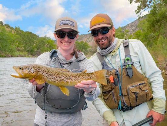 two ark anglers staff smiling and holding fish catch