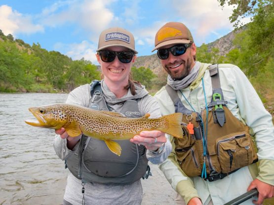 two ark anglers staff smiling and holding fish catch