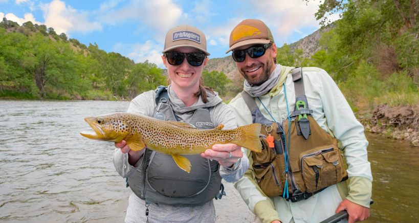 two ark anglers staff smiling and holding fish catch