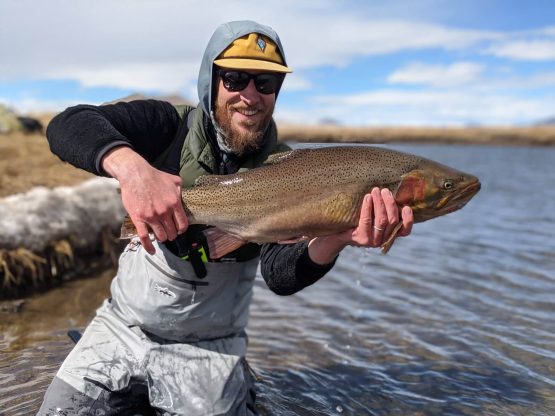 man holding big catch on the south platte dream stream